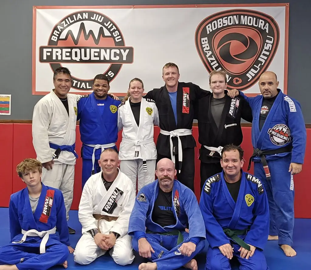 Adults practicing Brazilian Jiu Jitsu at Frequency Martial Arts in Bloomington, IL, improving fitness, self-defense, and confidence.