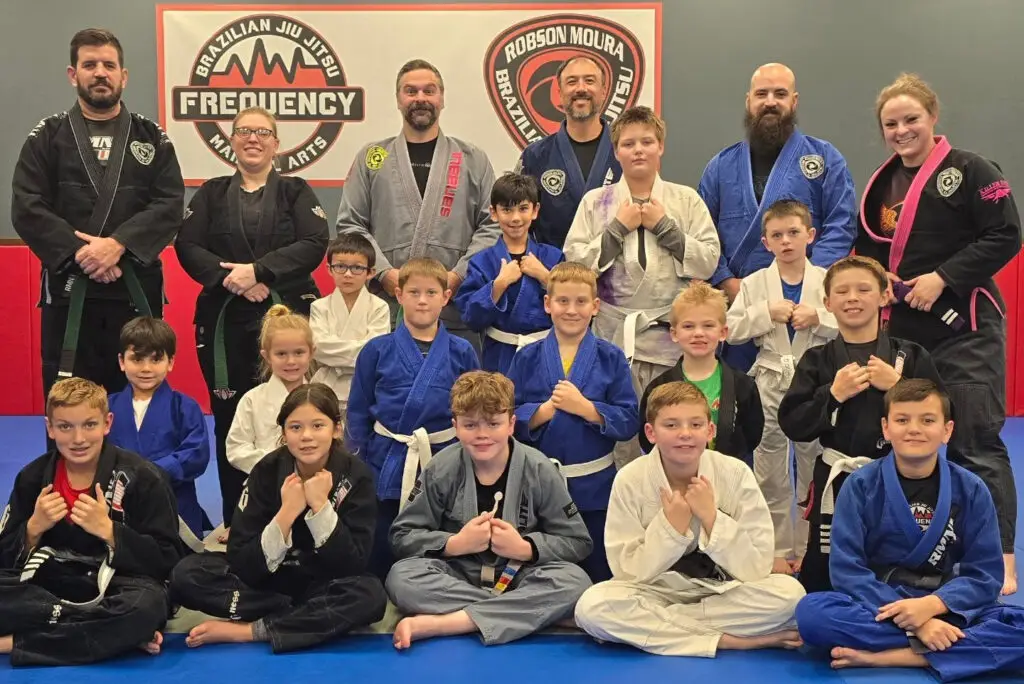 Children practicing Brazilian Jiu Jitsu at Frequency Martial Arts in Bloomington, IL, learning discipline, confidence, and self-defense.